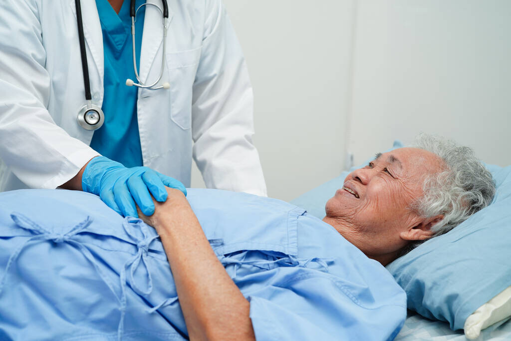 doctor holding hands asian elderly woman patient, help and care