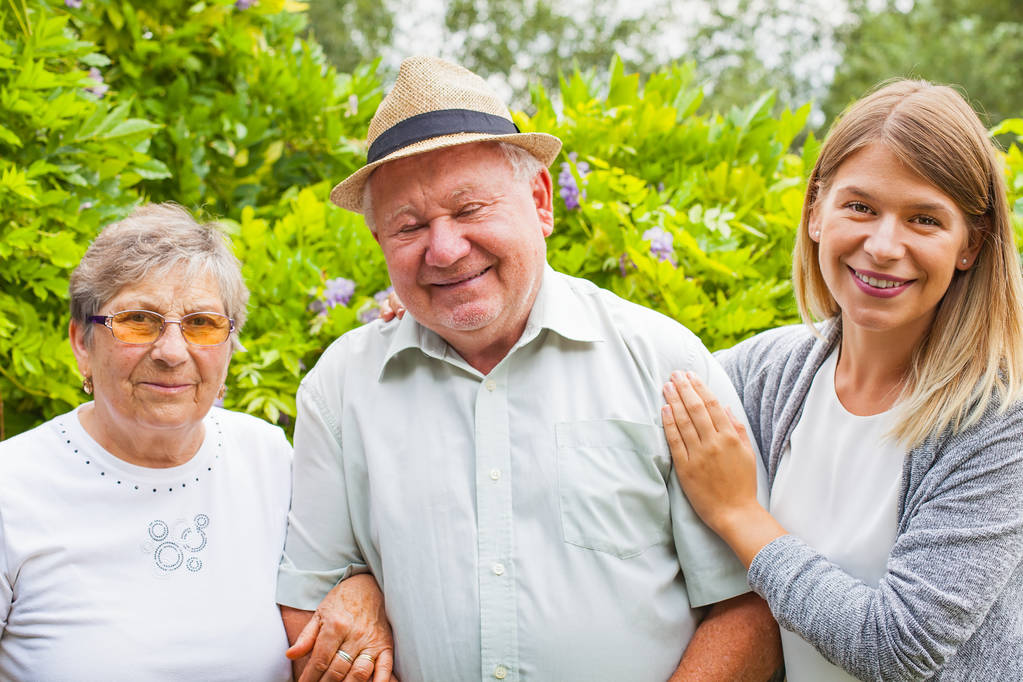 elderly couple with granddaughter in the park