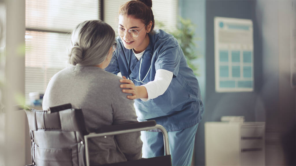 stock photo senior woman wheelchair being cared nurse