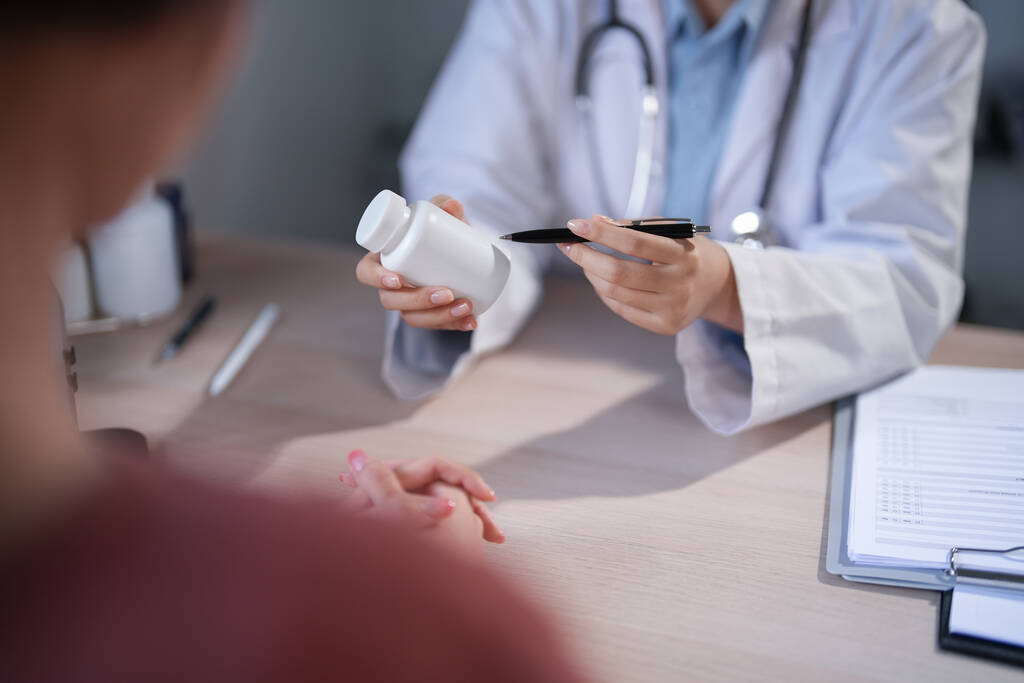 Healthcare professional speaking with an older adult